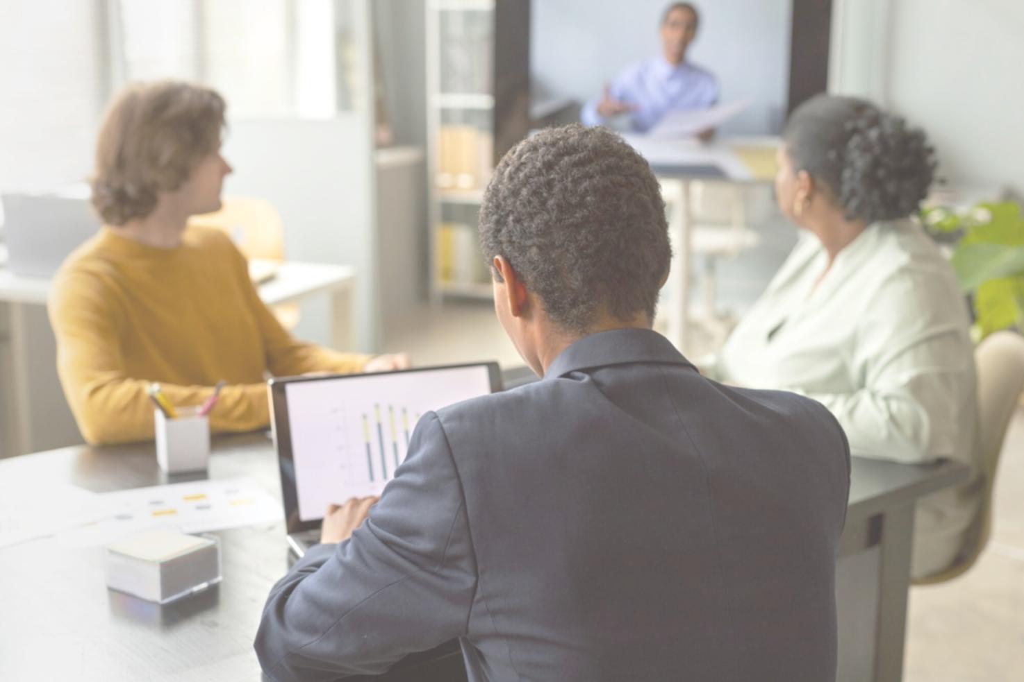 Professional business valuation meeting with charts, graphs and financial projections displayed on conference table