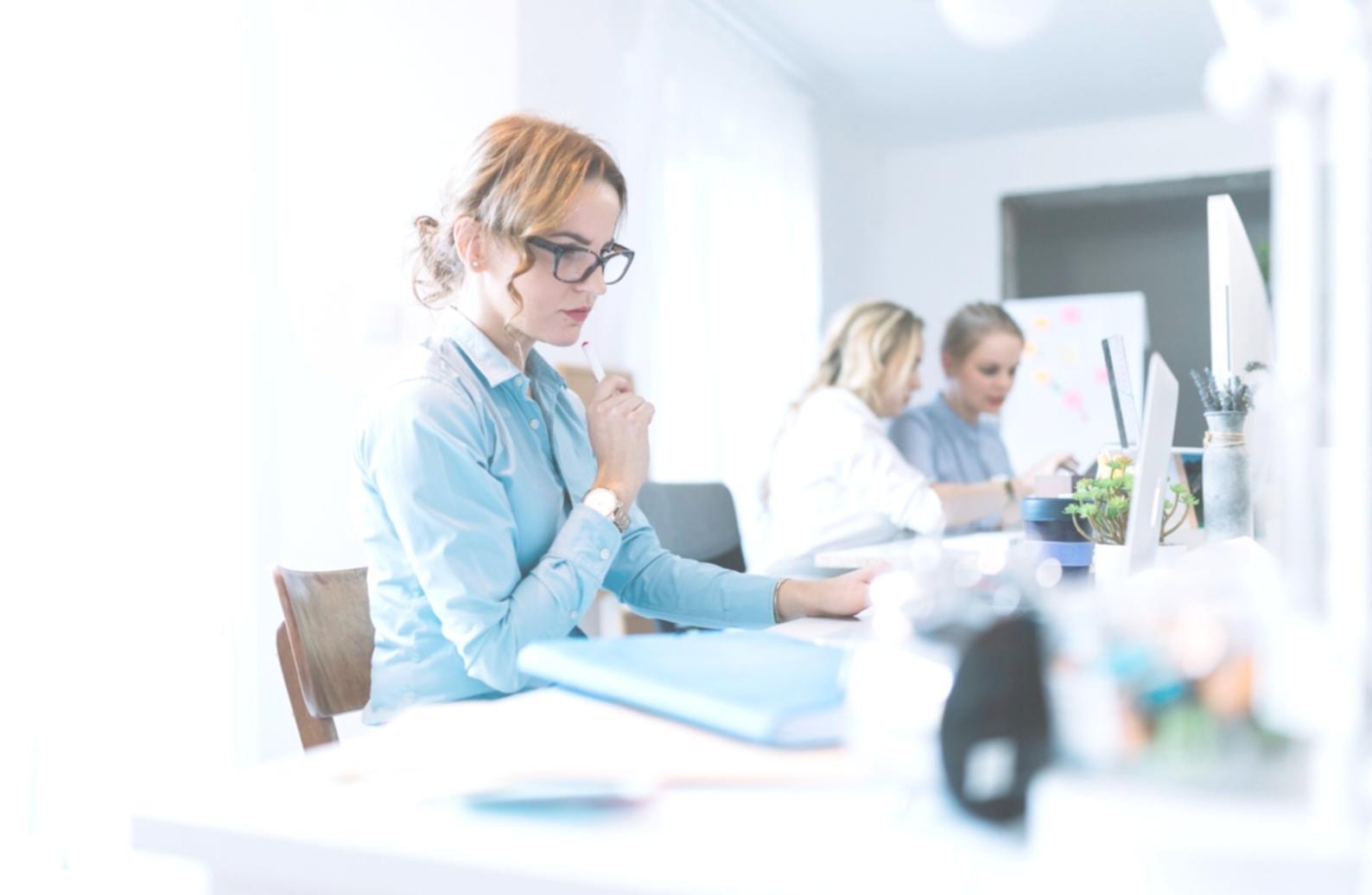 Business professionals reviewing documents and financial statements during acquisition meeting