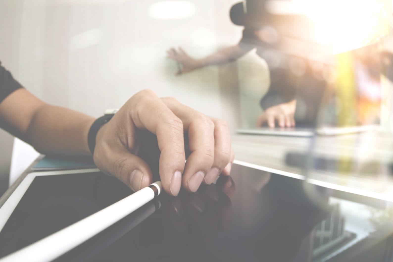 Detailed financial analysis documents spread across desk with calculator and laptop showing business metrics