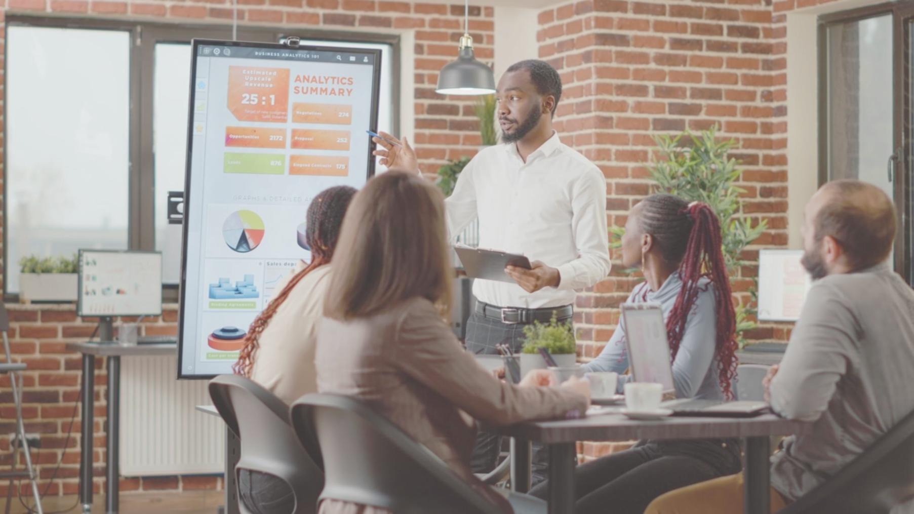Business professionals reviewing acquisition documents and financial reports in a modern office setting
